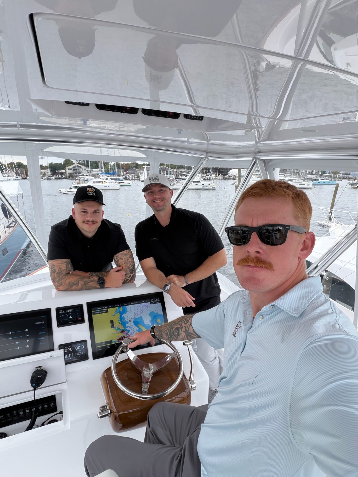 Ryan Gunning, founder of The Calm Seas Project, at the helm of a boat with project members